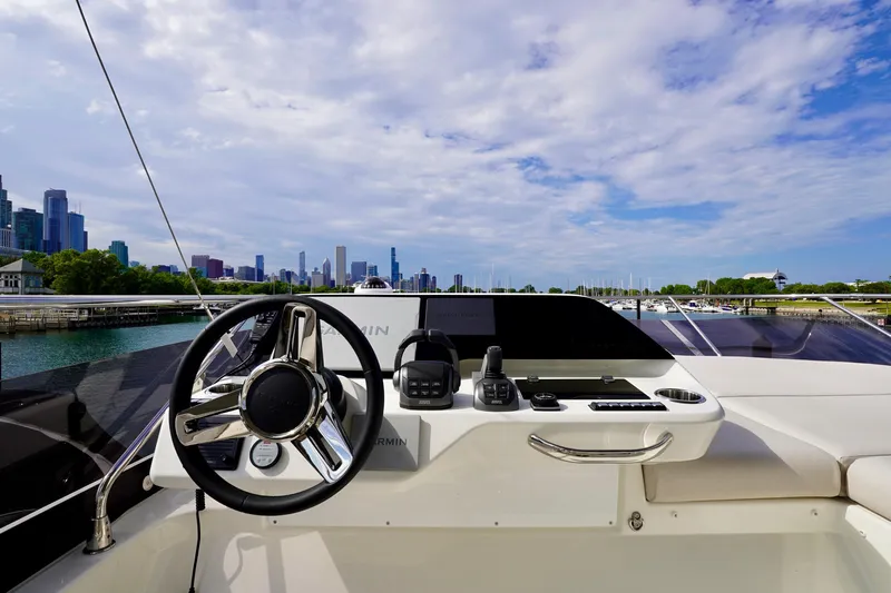  Yacht Photos Pics Luxury yacht Prestige F5.7 (2025) helm with city skyline and marina view.