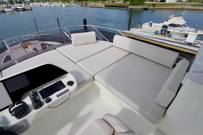  Yacht Photos Pics Luxurious 2025 Prestige F5.7 yacht deck with plush seating and marina view.