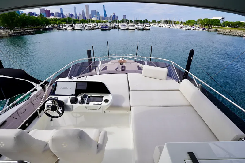  Yacht Photos Pics Luxurious 2025 Prestige F5.7 yacht with spacious deck and city skyline view.