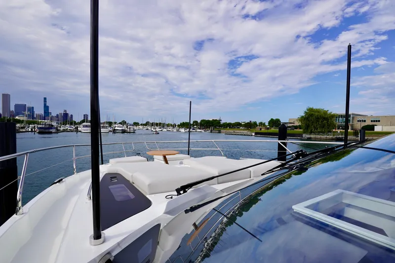  Yacht Photos Pics 2025 Prestige F5.7 yacht docked in marina with city skyline and blue sky.