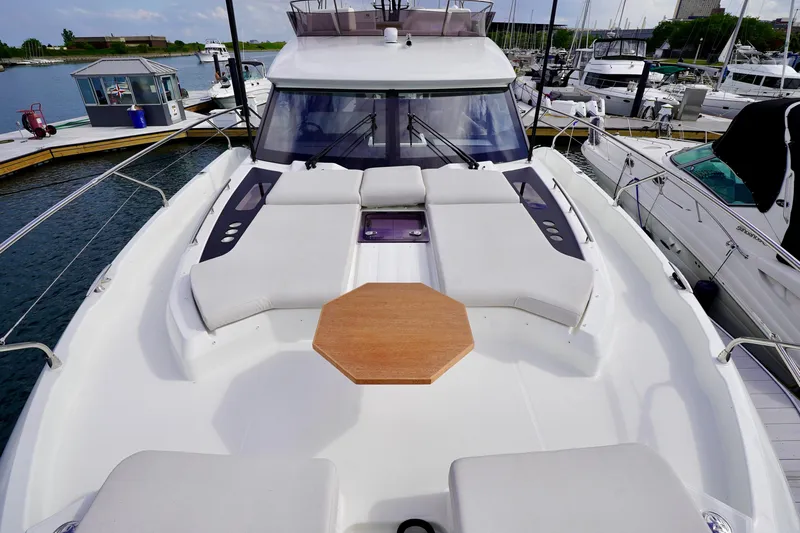  Yacht Photos Pics Prestige F5.7 yacht 2025 model, featuring spacious deck and seating area at marina.