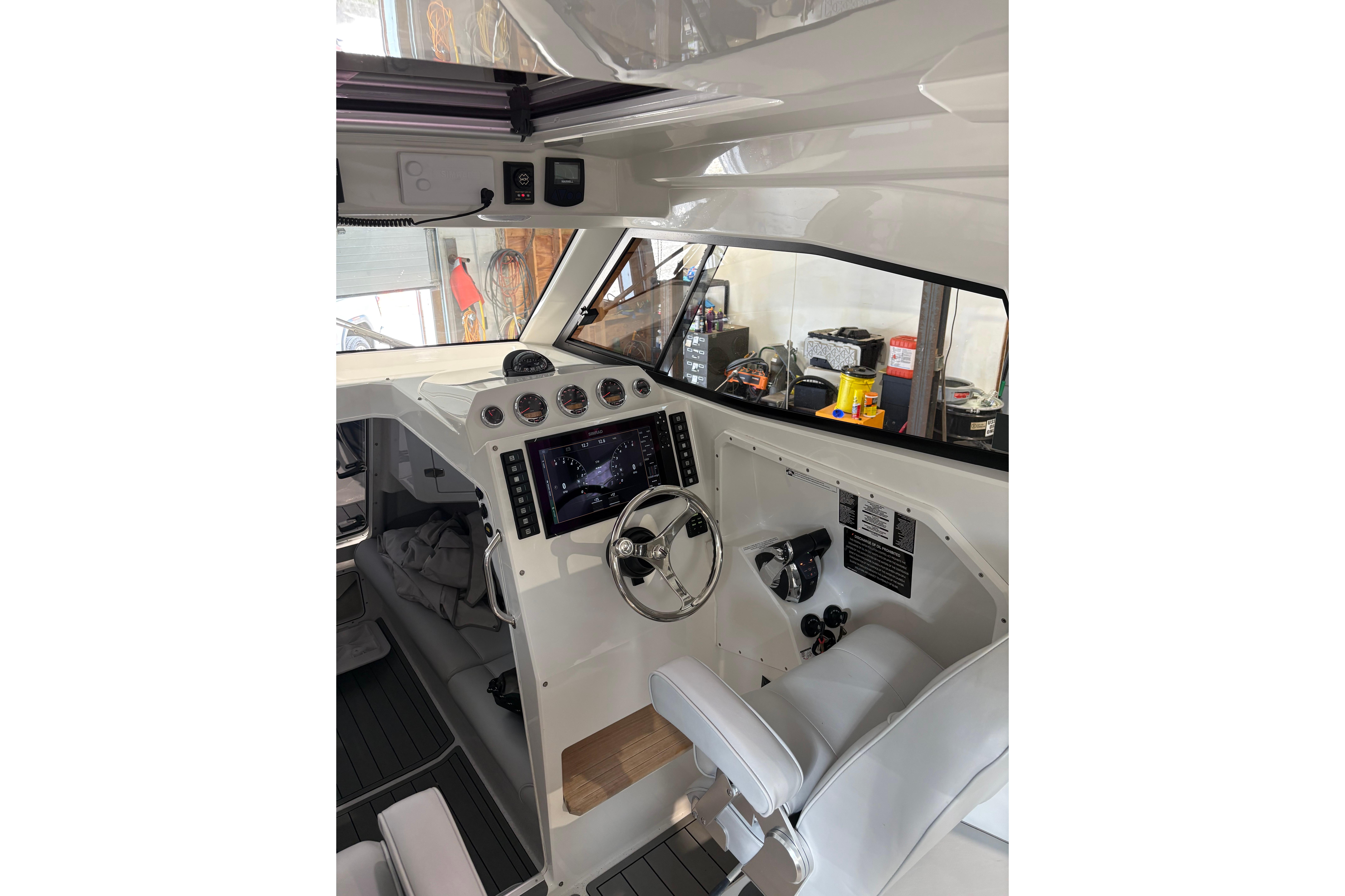 Interior of 2020 Protector 310 Targa boat with modern dashboard and steering wheel.