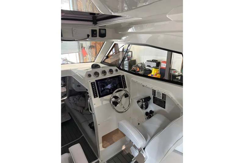 Protector Yacht Photos Pics Interior of 2020 Protector 310 Targa boat with modern dashboard and steering wheel.