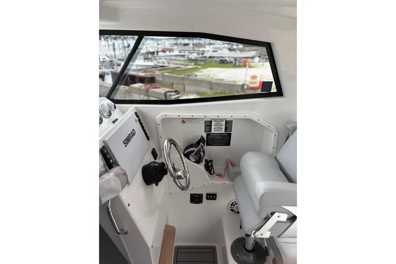 Protector Yacht Photos Pics Interior of 2020 Protector 310 Targa boat with steering wheel and navigation equipment.