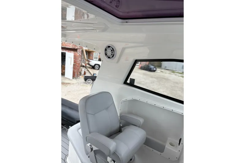 Protector Yacht Photos Pics Interior of 2020 Protector 310 Targa boat with gray seating and window view.