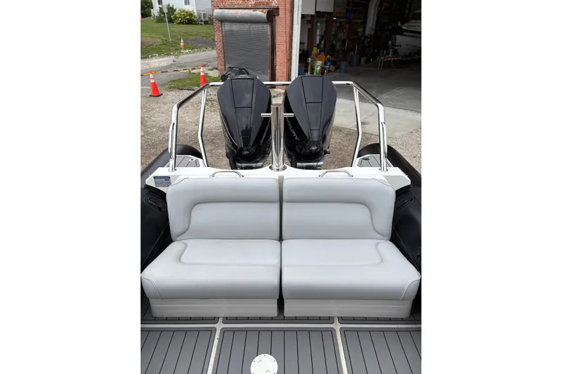 Protector Yacht Photos Pics 2020 Protector 310 Targa boat with dual outboard engines and cushioned seating.