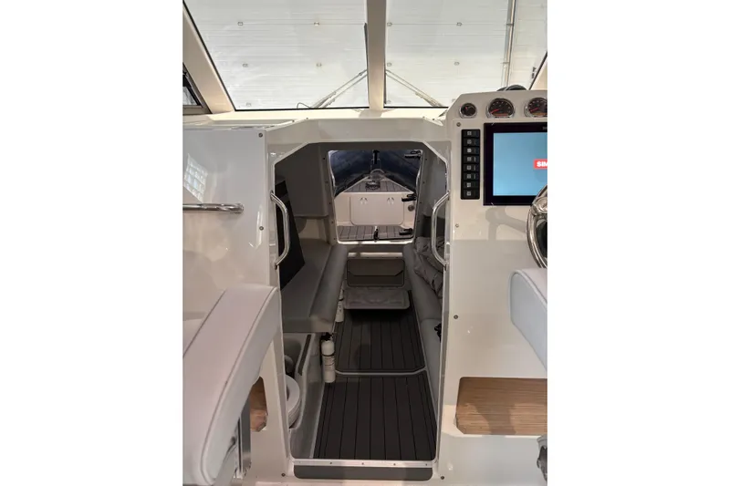 Protector Yacht Photos Pics Interior view of 2020 Protector 310 Targa boat, featuring modern controls and seating.