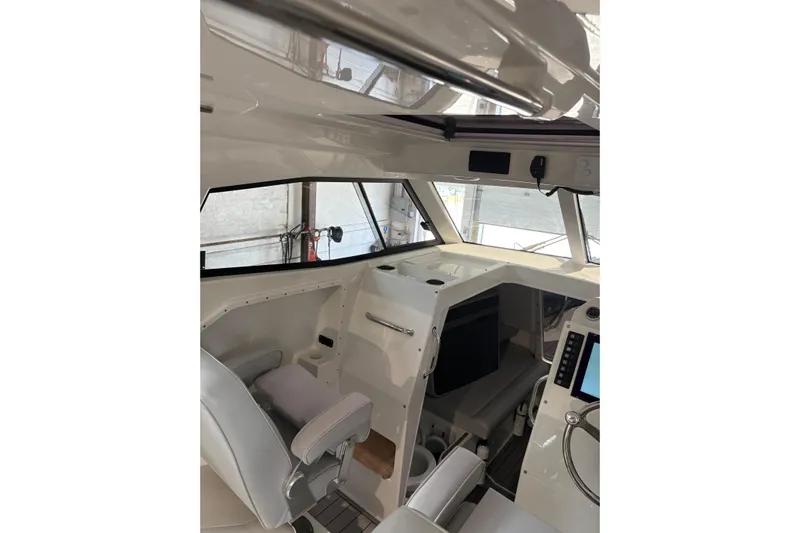 Protector Yacht Photos Pics Interior of 2020 Protector 310 Targa boat, featuring modern helm and seating.