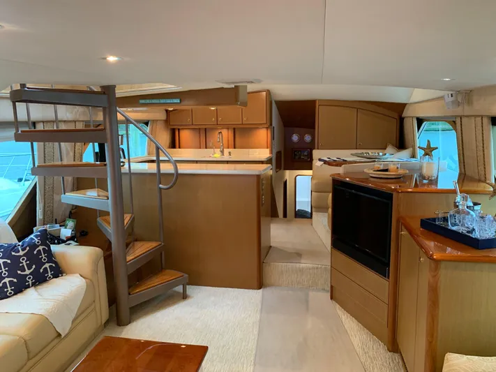  Yacht Photos Pics Luxurious interior of 2004 Ocean Yachts 57 Odyssey with elegant wood finishes and spiral staircase.