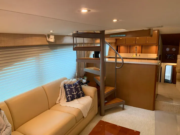  Yacht Photos Pics Luxurious interior of 2004 Ocean Yachts 57 Odyssey with spiral staircase and cozy seating area.