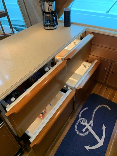  Yacht Photos Pics 2004 Ocean Yachts 57 Odyssey kitchen with open drawers and anchor-themed rug.