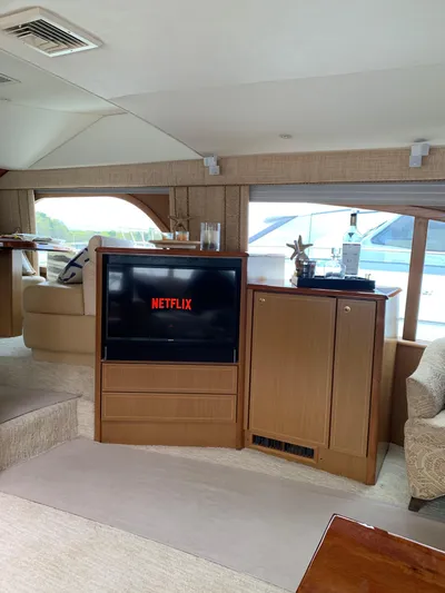  Yacht Photos Pics Luxurious 2004 Ocean Yachts 57 Odyssey interior with TV displaying Netflix.