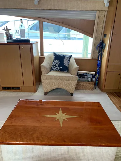  Yacht Photos Pics Luxurious interior of 2004 Ocean Yachts 57 Odyssey with elegant seating and wooden table.