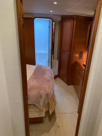  Yacht Photos Pics Interior of 2004 Ocean Yachts 57 Odyssey, featuring cozy bedroom and wooden cabinetry.