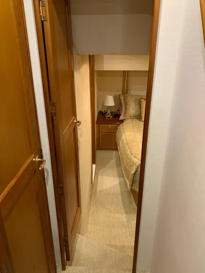  Yacht Photos Pics Cozy bedroom interior of 2004 Ocean Yachts 57 Odyssey with wooden accents.