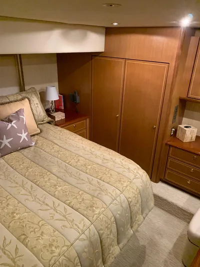  Yacht Photos Pics Luxurious bedroom in 2004 Ocean Yachts 57 Odyssey with elegant bedding and wooden cabinetry.