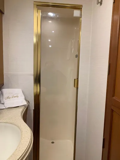  Yacht Photos Pics Luxurious bathroom shower in 2004 Ocean Yachts 57 Odyssey with gold trim.