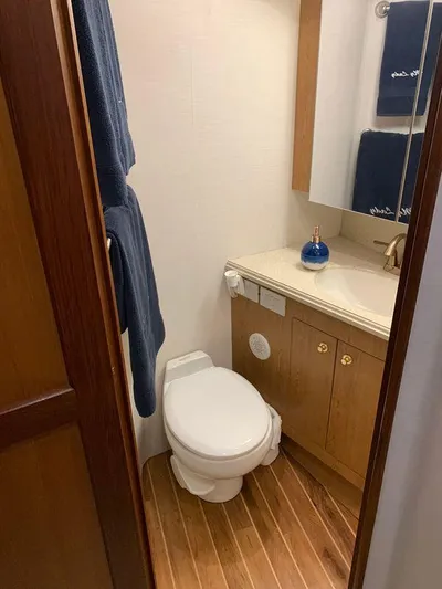  Yacht Photos Pics Bathroom interior of 2004 Ocean Yachts 57 Odyssey with wooden flooring and modern fixtures.