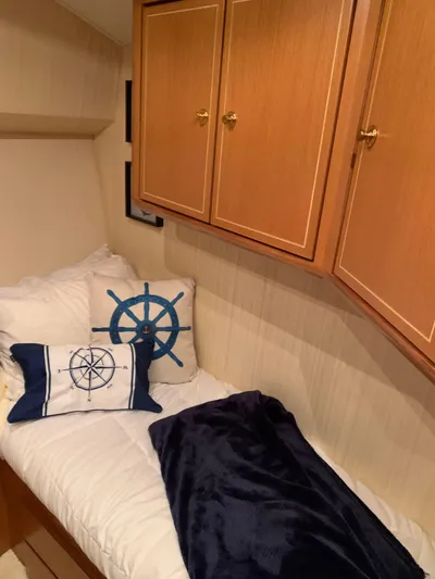  Yacht Photos Pics Cozy cabin bed with nautical-themed pillows in 2004 Ocean Yachts 57 Odyssey.