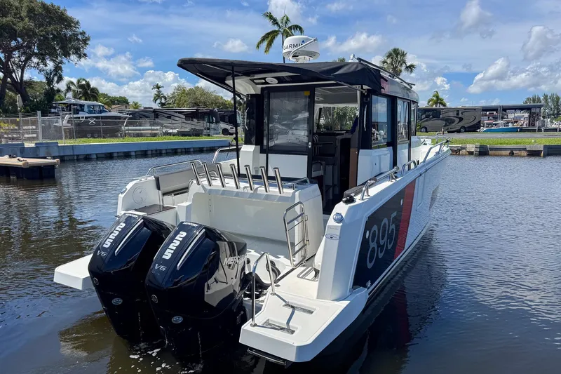  Yacht Photos Pics 2018 Jeanneau NC 895 boat with dual Mercury V6 engines docked on a sunny day.