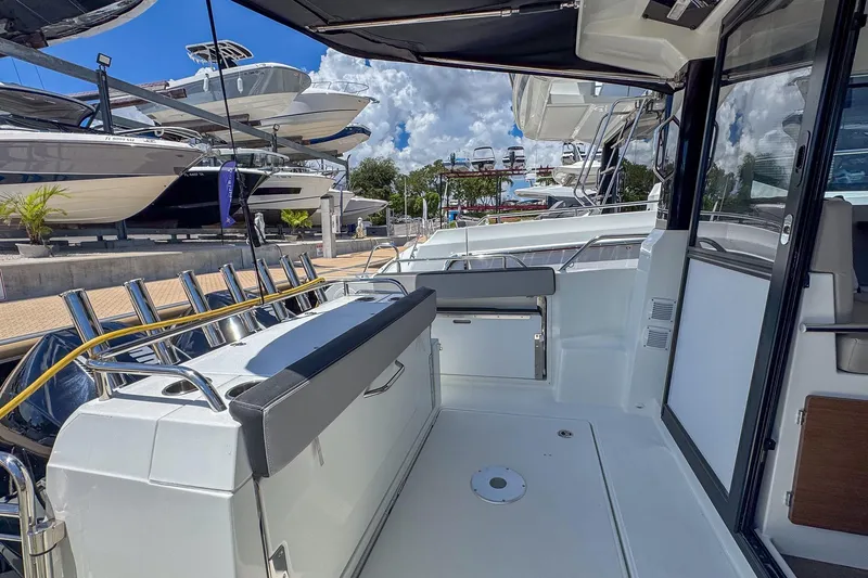  Yacht Photos Pics 2018 Jeanneau NC 895 boat interior with seating, docked under a blue sky.
