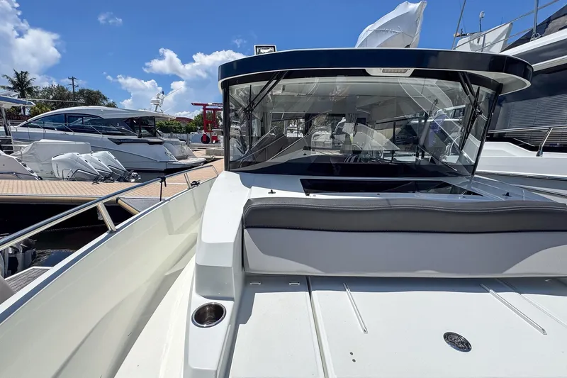 Yacht Photos Pics 2018 Jeanneau NC 895 boat docked under a clear blue sky.