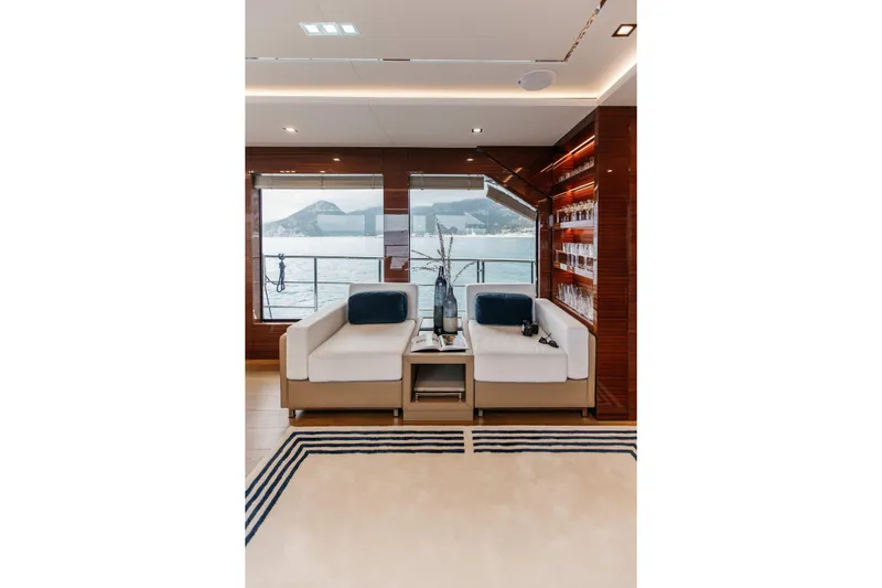 Papillon Yacht Photos Pics Luxurious interior of 2022 Bering 92 yacht with elegant seating and ocean view.