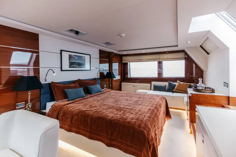 Papillon Yacht Photos Pics Luxurious 2022 Bering 92 yacht bedroom with elegant decor and ocean view windows.