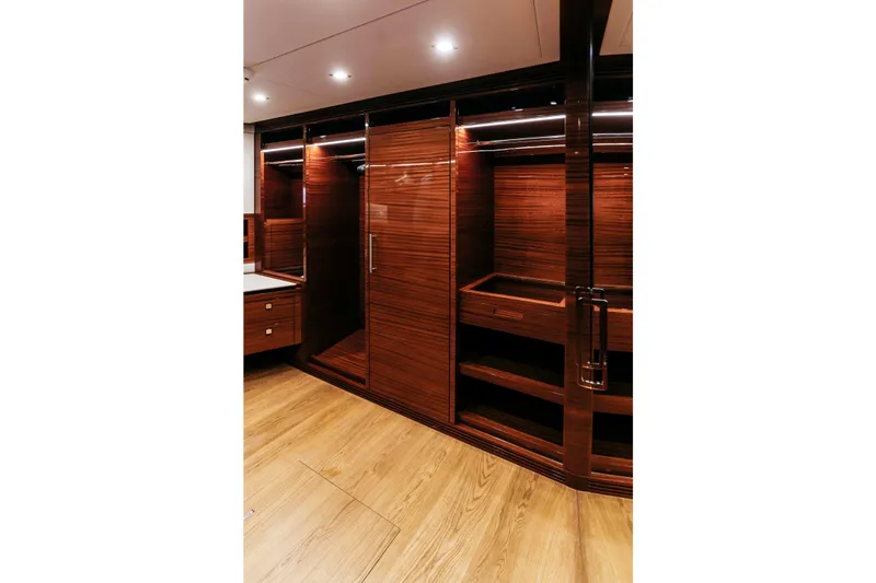 Papillon Yacht Photos Pics Luxurious wooden interior of 2022 Bering 92 yacht with elegant cabinetry and lighting.