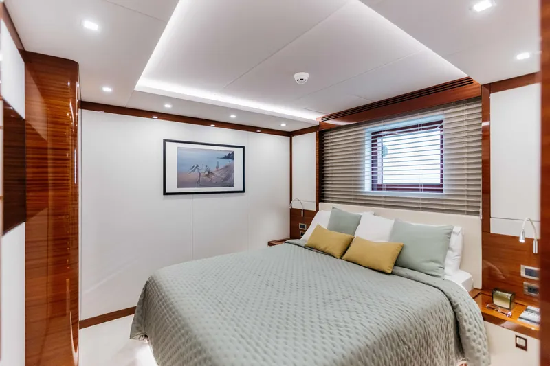 Papillon Yacht Photos Pics Luxurious bedroom interior on 2022 Bering 92 yacht with modern decor and cozy bedding.