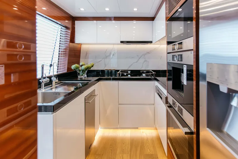 Papillon Yacht Photos Pics Luxurious modern kitchen in 2022 Bering 92 yacht with sleek appliances and elegant design.