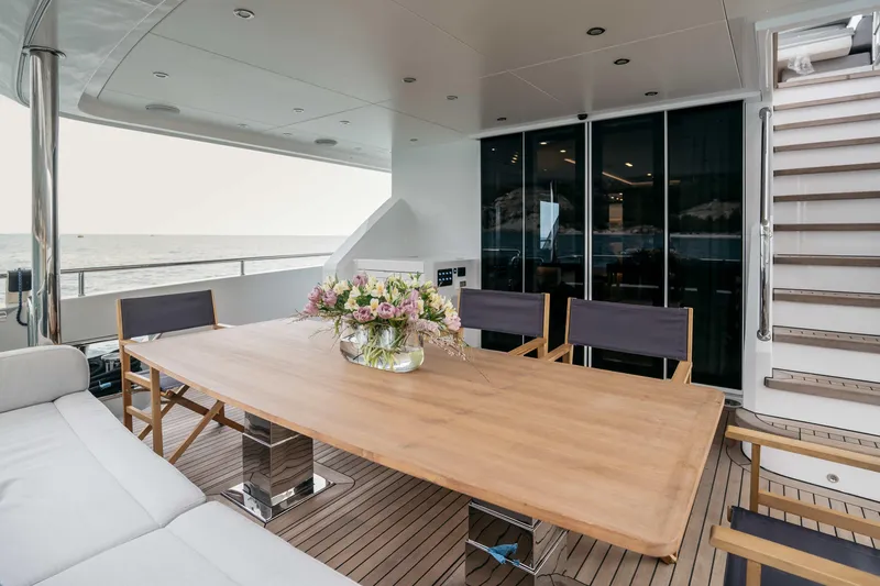 Papillon Yacht Photos Pics Luxurious 2022 Bering 92 yacht deck with elegant dining area and ocean view.
