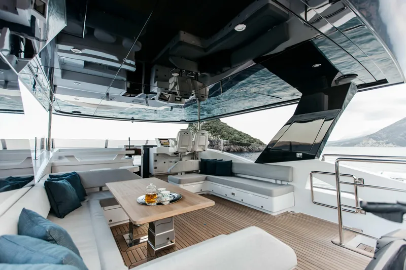 Papillon Yacht Photos Pics Luxurious 2022 Bering 92 yacht interior with elegant seating and scenic ocean view.