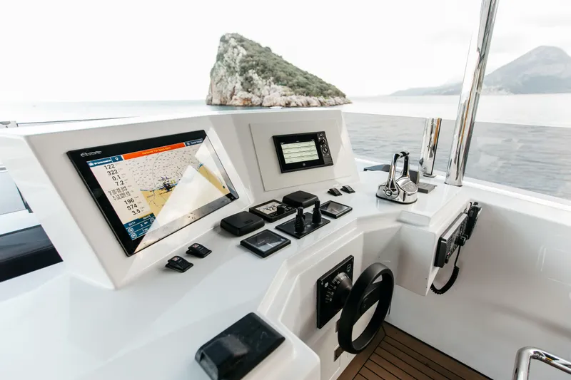 Papillon Yacht Photos Pics Helm of 2022 Bering 92 yacht with navigation screens and controls, ocean view.