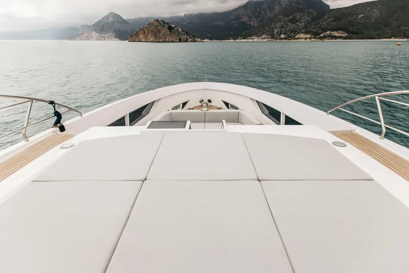 Papillon Yacht Photos Pics Luxurious 2022 Bering 92 yacht deck with scenic ocean and mountain views.