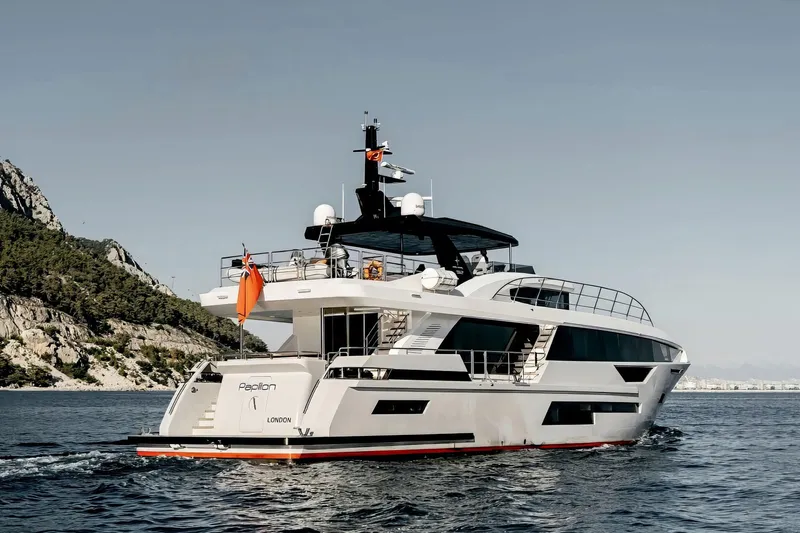 Papillon Yacht Photos Pics Luxury 2022 Bering 92 yacht cruising near rocky coastline.