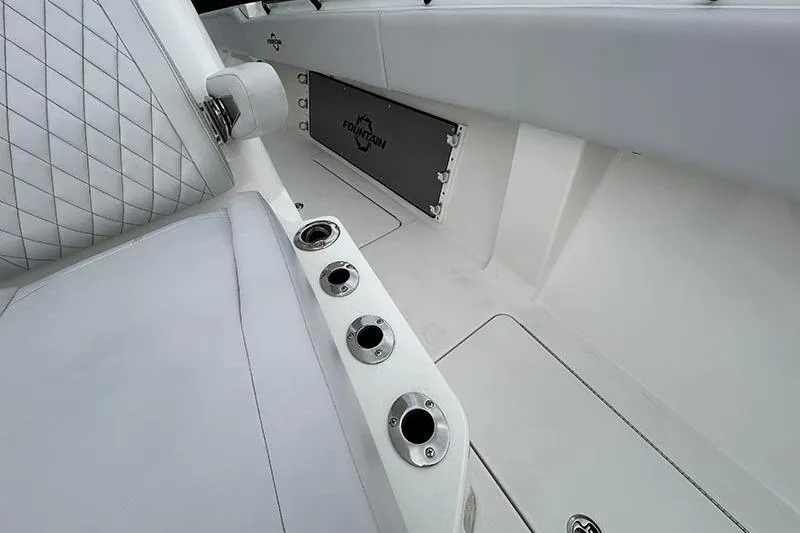  Yacht Photos Pics 2025 Fountain 38 Center Console interior with white seating and rod holders.