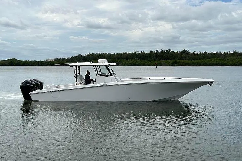  Yacht Photos Pics 2025 Fountain 38 Center Console boat cruising on calm water under cloudy skies.