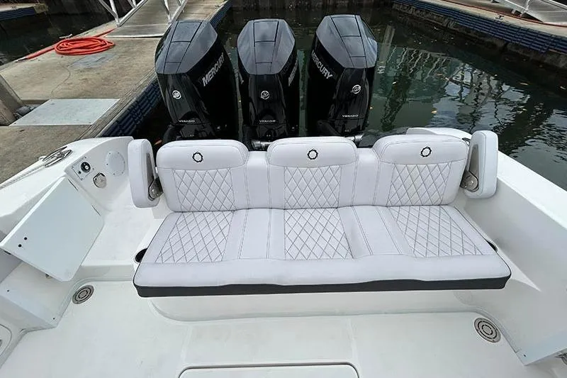  Yacht Photos Pics 2025 Fountain 38 Center Console with triple Mercury engines and luxurious white seating.