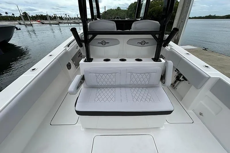  Yacht Photos Pics 2025 Fountain 38 Center Console boat interior with cushioned seating and sleek design.
