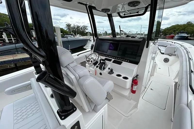  Yacht Photos Pics 2025 Fountain 38 Center Console boat interior with modern helm and seating at marina.