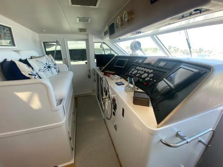  Yacht Photos Pics 1989 Hatteras Custom Cockpit interior with helm, gauges, and seating area.