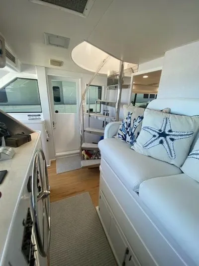  Yacht Photos Pics Interior of 1989 Hatteras Custom Cockpit yacht with spiral staircase and nautical decor.