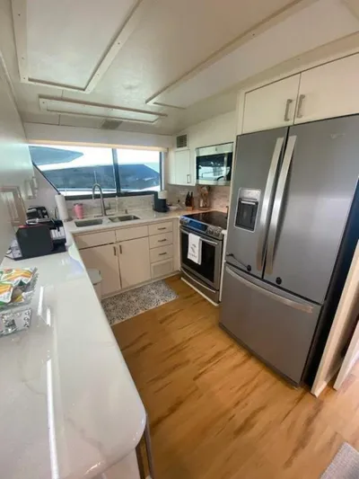  Yacht Photos Pics 1989 Hatteras Custom Cockpit kitchen with modern appliances and wood flooring.