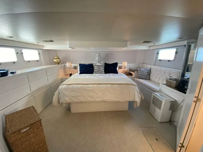  Yacht Photos Pics Luxurious bedroom interior of 1989 Hatteras Custom Cockpit yacht with elegant decor and ample lighting.