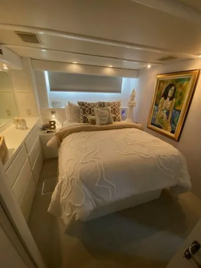 Yacht Photos Pics Luxurious bedroom in 1989 Hatteras Custom Cockpit yacht with elegant decor and artwork.