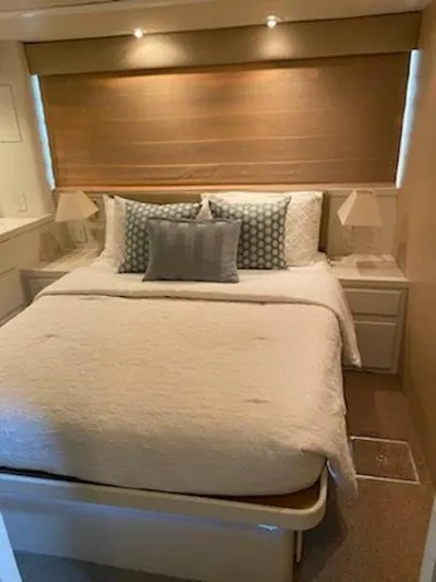  Yacht Photos Pics 1989 Hatteras Custom Cockpit bedroom with cozy bedding and soft lighting.