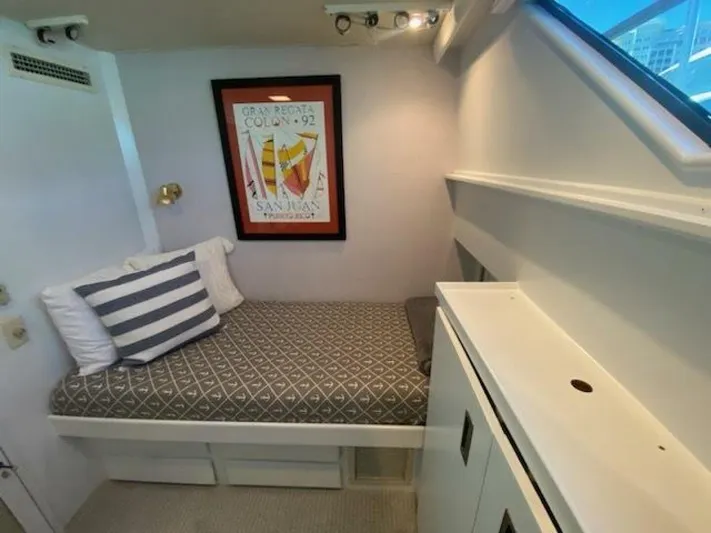  Yacht Photos Pics 1989 Hatteras Custom Cockpit interior with cozy bed, nautical decor, and framed artwork.