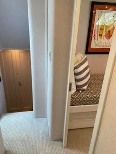  Yacht Photos Pics 1989 Hatteras Custom Cockpit interior with cozy bedroom and striped pillow.