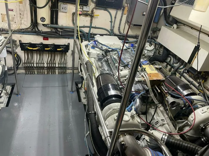  Yacht Photos Pics Engine room of 1989 Hatteras Custom Cockpit yacht, showcasing mechanical components and wiring.